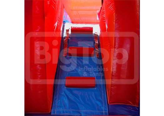 Inflatable slide with red and blue colors, branded with 'BigTop Inflatables & Tents'.