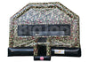 Camo-themed inflatable bounce house with mesh windows, featuring a military camouflage pattern. It includes a basketball hoop and is designed for outdoor play.