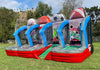 Outdoor inflatable sports bounce house set on a grassy field, featuring basketball, baseball, soccer, and football themed walls with target holes, trees, and a hill in the background.