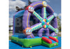 A large inflatable bounce house with a purple Ferris wheel design, green base, blue entrance tunnel, and red slide, photographed outdoors on a blue ground cover under a cloudy sky.