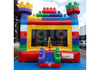 A colorful inflatable bounce house front live view designed to look like a giant building with a castle-like structure on top, featuring a vibrant red, yellow, green, and blue color scheme with a transparent front panel.