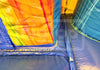 Colorful inflatable slides with a blue base and multicolored top.