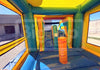 Colorful inflatable bounce house with a slide and climbing wall.