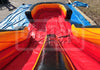 Inflatable slide with red, yellow, and black colors on a blue tarp.