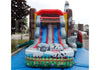 A colorful inflatable playground slide with a farm theme, featuring cartoon cow and sheep faces on the slide and base, set up outdoors on a blue ground cover.