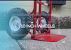Red hand truck with 10 inch wheels on a concrete surface.
