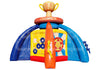 Inflatable bounce house with a trophy cup at the top, blue arch walls, a yellow and white target wall, and an orange central slide or climbing element on a white background.