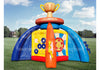 A colorful inflatable outdoor game structure on a grassy field under a blue sky. The inflatable features a large gold trophy at the top with '#1' and 'CHAMPION' text, blue arches, a yellow target panel, and an orange central cone.