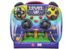 Inflatable bouncy castle designed like a retro video game controller, featuring colorful graphics, 'LEVEL UP' text, and game-style buttons and dials on a white background.