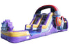 A purple inflatable party slide with yellow and blue accents, featuring a large archway at the top, a splash pool at the front, and a side wall with a red and blue target design.