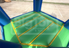 Inflatable bounce house with green platform and blue sides, featuring 'Big Top Inflatables & Tents' branding.