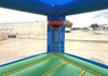 Inflatable bounce house with blue roof and green floor, featuring 'Inflatable Fun & Games' branding.