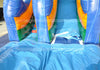 Inflatable slide with blue, orange, and green colors on a clear day.