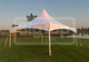 A white high-peak frame tent with tension cross cables and no center pole, exterior view, designed for outdoor events.