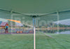 A white 20x20 high-peak frame tent with tension cross cables and no center pole, outside view, designed for outdoor events.