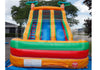 Colorful inflatable water slide with palm tree designs on a clear sky background.