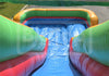 Inflatable water slide with green, red, and blue colors on a grassy background