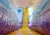 Inflatable slide with colorful walls and a yellow floor