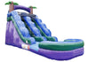 An inflatable double slide water slide with a purple and green design, featuring palm tree decorations at the top, shown against a plain white background.