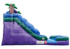 Inflatable outdoor slide with a purple and blue mountain design, green slope, palm tree decoration, and a small pool area on a white background.