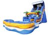 Inflatable water slide bounce house with a blue ocean wave design, yellow and orange wave details, palm tree arches, and a black slide chute, isolated on a white background.
