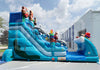 Large inflatable water slide with cartoon characters on a clear day.