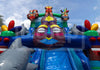 Colorful inflatable slide with tiki masks and dolphins against a blue sky.